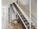 View of a carpeted staircase with white railings, complemented by durable, wood-look laminate flooring at 1655 58Th S Ter # 7, St Petersburg, FL 33712