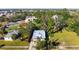 An aerial view of a cozy home with a large yard, surrounded by lush trees in a quiet neighborhood at 1717 32Nd St, Sarasota, FL 34234