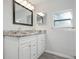 Bathroom featuring a double sink vanity with marble countertop and a large framed mirror at 1717 32Nd St, Sarasota, FL 34234