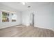Light-filled bedroom with wood-look flooring and large windows offering neighborhood views at 1717 32Nd St, Sarasota, FL 34234