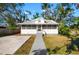 Charming single-story home featuring a new metal roof, a screened-in front porch, and a quaint facade at 1717 32Nd St, Sarasota, FL 34234