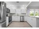 Updated kitchen featuring stainless appliances, light wood-look floors, and bright white cabinetry at 1717 32Nd St, Sarasota, FL 34234