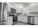 Modern kitchen with stainless steel appliances, white cabinets, and granite countertops at 1717 32Nd St, Sarasota, FL 34234