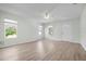 Bright living room featuring wood-look floors, a ceiling fan, and plenty of natural light at 1717 32Nd St, Sarasota, FL 34234