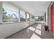 Inviting screened front porch with wood-look tile flooring and a bright, open atmosphere at 1717 32Nd St, Sarasota, FL 34234