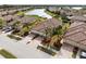 Beautiful aerial view of tile-roofed homes in a well-maintained community with lush landscaping and serene lake views at 20289 Benissimo Dr, Venice, FL 34293