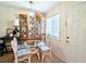 Bright dining area featuring a glass top table with wicker chairs and a large display cabinet at 2075 Canal Dr # L36, Bradenton, FL 34207