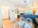 Open-concept living room with dining area featuring a comfortable sofa and view to the kitchen at 2075 Canal Dr # L36, Bradenton, FL 34207
