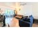 Bright living room featuring hardwood floors, two couches, and dining area with large windows at 2075 Canal Dr # L36, Bradenton, FL 34207