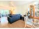 Open-concept living room with dining area featuring a comfortable sofa and view to the lanai at 2075 Canal Dr # L36, Bradenton, FL 34207