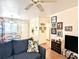 Open-concept living room with dining area featuring a comfortable sofa and view to the kitchen at 2075 Canal Dr # L36, Bradenton, FL 34207