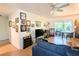 Bright living room with contemporary decor, fan, and sliding door access to the lanai at 2075 Canal Dr # L36, Bradenton, FL 34207