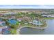 Aerial view of a community with tennis court, pool, and waterfront homes at 328 Aria Dr, Nokomis, FL 34275
