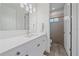 Clean and modern bathroom with white vanity, stylish lighting, and a glass-enclosed shower at 328 Aria Dr, Nokomis, FL 34275