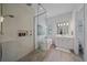 Bright bathroom with a luxurious soaking tub, walk-in shower, and white vanity at 328 Aria Dr, Nokomis, FL 34275