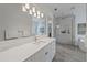 Well-lit bathroom with double sinks, a soaking tub, and a frameless glass shower at 328 Aria Dr, Nokomis, FL 34275