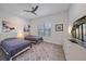 Bright guest bedroom with twin beds, modern ceiling fan, and plantation shutters at 328 Aria Dr, Nokomis, FL 34275