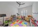 A colorful bedroom with toys, a ceiling fan, and natural light from the window at 328 Aria Dr, Nokomis, FL 34275