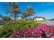 Community entrance with vibrant flowers and lush greenery at 328 Aria Dr, Nokomis, FL 34275