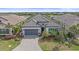 Beautiful single-story home with lush landscaping, a gray tile roof, and a paver driveway at 328 Aria Dr, Nokomis, FL 34275