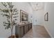 Bright foyer with stylish decor, wood-look flooring, high ceilings, and a modern chandelier at 328 Aria Dr, Nokomis, FL 34275