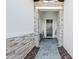 Front entrance with stone veneer and an inviting gray paved walkway and covered entry at 328 Aria Dr, Nokomis, FL 34275