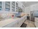 Close-up of the well-equipped kitchen with stainless steel appliances, a tiled backsplash, and ample counter space at 328 Aria Dr, Nokomis, FL 34275