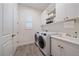 A well-equipped laundry room featuring a washer, dryer, and ample cabinet space at 328 Aria Dr, Nokomis, FL 34275