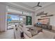 Spacious living area with floor-to-ceiling glass doors opening to a screened-in outdoor pool area at 328 Aria Dr, Nokomis, FL 34275