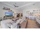 Open-concept living room boasts a modern design, adjacent kitchen, and grand piano for seamless entertainment at 328 Aria Dr, Nokomis, FL 34275