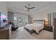 Spacious main bedroom featuring tray ceiling, ceiling fan, and access to the outdoor patio at 328 Aria Dr, Nokomis, FL 34275