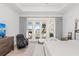 Bedroom with natural light, access to the outside, a ceiling fan and luxury plank floors at 328 Aria Dr, Nokomis, FL 34275
