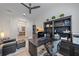Well-lit home office featuring a custom desk, shelving, and a comfortable chair at 328 Aria Dr, Nokomis, FL 34275