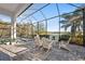 A screened-in patio features a spa and beautiful lake views at 328 Aria Dr, Nokomis, FL 34275