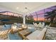 Spacious screened patio with comfortable seating, pool, and serene sunset views at 328 Aria Dr, Nokomis, FL 34275