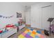 Cozy playroom with colorful floor tiles, a toy chest, play castle, and sliding closet doors at 328 Aria Dr, Nokomis, FL 34275