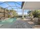 Relaxing screened-in patio featuring a pool with a lake view and comfortable seating at 328 Aria Dr, Nokomis, FL 34275