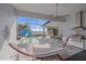An outdoor living space showcasing a pool, screened lanai, dining area, grill, and a hammock at 328 Aria Dr, Nokomis, FL 34275