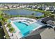 Overhead view of a community pool and the nearby lake with seating and landscaping at 5546 Appleton Shore Dr, Apollo Beach, FL 33572