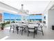Bright dining area with ocean views, a modern chandelier, and ample seating for sophisticated dining and entertaining at 6100 Midnight Pass Rd # 401, Sarasota, FL 34242