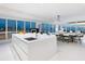 Open-concept kitchen with a large island, modern appliances, and stunning ocean views for seamless entertaining at 6100 Midnight Pass Rd # 401, Sarasota, FL 34242