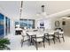 Bright, open-concept living and dining area with stunning ocean views, fireplace, and modern decor at 6100 Midnight Pass Rd # 401, Sarasota, FL 34242