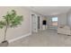 Bedroom with carpet flooring, a window, light gray walls, and an indoor tree in a pot at 6284 Talon Preserve Dr, Nokomis, FL 34275