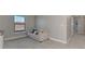 Bedroom with carpet flooring, a window, and light gray walls, next to an upstairs hallway at 6284 Talon Preserve Dr, Nokomis, FL 34275