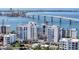 Stunning aerial view of waterfront condos with bridge and bay, showcasing luxurious coastal living at 223 Golden Gate Point # 2A, Sarasota, FL 34236