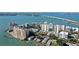 Stunning aerial view of waterfront condo buildings, showcasing their proximity to the water, beautiful landscape, and coastal setting at 223 Golden Gate Point # 2A, Sarasota, FL 34236