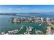 Breathtaking aerial view of waterfront condo buildings, a bridge, marina, and scenic coastline, showcasing its prime location at 223 Golden Gate Point # 2A, Sarasota, FL 34236