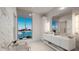 Spa-like bathroom with modern vanity, soaking tub, and a scenic waterfront view at 223 Golden Gate Point # 2A, Sarasota, FL 34236