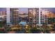 Modern high-rise condominiums boast luxurious amenities, including a pool, lush landscaping, and convenient parking at 223 Golden Gate Point # 2A, Sarasota, FL 34236