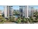 Luxury apartment building with sleek design, palm trees, a pool, and scenic city views at 223 Golden Gate Point # 2A, Sarasota, FL 34236